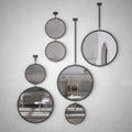 Round mirrors hanging on the wall reflecting interior design scene, minimalist classic white living room and kitchen, modern Royalty Free Stock Photo