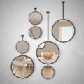 Round mirrors hanging on the wall reflecting interior design scene, minimalist white and wooden kitchen, modern architecture Royalty Free Stock Photo