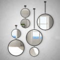 Round mirrors hanging on the wall reflecting interior design scene, modern stylish empty room with panoramic windows, modern