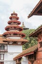 Round, multi-tiered tower in Nasal Chowk with Taleju temple just visible in the background. Durbar Square, Kathmandu Royalty Free Stock Photo