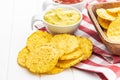Round nacho chips and avocado dip. Yellow tortilla chips and guacamole in bowl Royalty Free Stock Photo