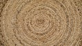 Round natural raffia rug with a spiral braided design and concentric circles Royalty Free Stock Photo
