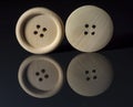 Round natural wooden sewing buttons isolated on black background. Royalty Free Stock Photo