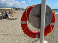 Round non-sinking red life buoy for safety to save the lives of drowning people tourists on the beach in a warm eastern tropical