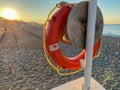 Round non-sinking red life buoy for safety to save the lives of drowning people tourists on the beach in a warm eastern tropical Royalty Free Stock Photo