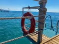 Round non-sinking red lifebuoy for safety to save the lives of drowning people tourists against the background of the sea in a