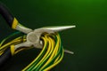 Round nose pliers with wires on dark green background. Electricity repair idea Royalty Free Stock Photo