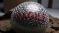 Fragile item wrapped in bubble wrap with red warning text Royalty Free Stock Photo