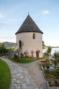 Round old chapel in the cemetery at the church of Maria Worth on the shores of Lake Worthersee in the Austrian mountains. Royalty Free Stock Photo