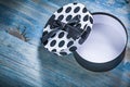 Round opened gift box with blue bow on wooden board holidays con Royalty Free Stock Photo