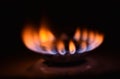 Round orange blue burning gas flame black background close up Royalty Free Stock Photo