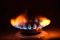 Round orange blue burning gas flame black background close up Royalty Free Stock Photo