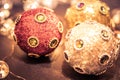 Round ornaments covered in rich jewels and glitter, baubles and soft lights for Christmas holiday, split tone