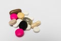 Round pills and oval hard and soft capsules on white background Royalty Free Stock Photo