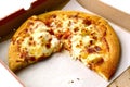 Round pizza in box close up photo