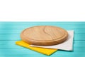 Round pizza cutting board and tablecloth on blue wooden background isolated on white. Top view. Copy space and mock up. Royalty Free Stock Photo