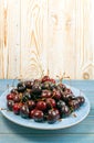 Fresh Overripe ripe Cherries on Blue Rustic Wooden Background Royalty Free Stock Photo