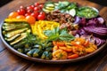 a round platter loaded with colorful grilled veggies under natural light