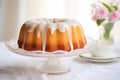 Delicious round pound cake baked in bundt cake mold on table