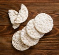 Round puffed rice cakes and broken in half on a wooden background. Top view Royalty Free Stock Photo