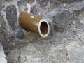 Round rain dry ceramic pipe in the stone wall