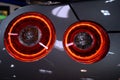 Round rear light of japanese sport car, silver chassis.