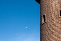 Round red brick block tower with round window in blue clear sky Royalty Free Stock Photo