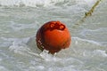 Round red buoy riding the sea waves Royalty Free Stock Photo