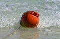 Round red buoy riding the sea waves Royalty Free Stock Photo