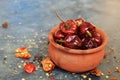 Round red chillies on the small clay pot. Royalty Free Stock Photo