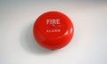 Round red fire alarm mounted on a cement wall Royalty Free Stock Photo