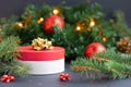 Round red gift box with gold ribbon, bow and balls for the happy new year. surprise, present for Christmas Royalty Free Stock Photo