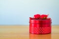 Round red gift box with ribbon bow on wooden table with copy spa Royalty Free Stock Photo