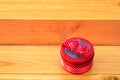 Round red gift box with ribbon bow on wooden table with copy spa Royalty Free Stock Photo