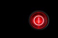 Round red power on and off button or switch with retro illumination glowing in the dark macro photography Royalty Free Stock Photo
