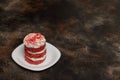 Round red velvet cake with cream on white plate Royalty Free Stock Photo