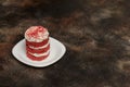 Round red velvet cake with cream on white plate Royalty Free Stock Photo