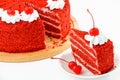 Round red velvet cake on a wooden plate decorated with canned cherries Royalty Free Stock Photo