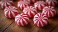 Round red and white candies on a wooden surface Royalty Free Stock Photo