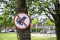 Round red and white no dogs poop zone sign in front of children playground in a neighbourhood Royalty Free Stock Photo