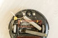 The round robot vacuum cleaner collapsed on the floor. The vacuum cleaner washer is broken. Repair of household