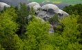 Round rock formations attract climbers. sandstone rock towers polished by wind erosion. deciduous, mixed forest with beeches in ea Royalty Free Stock Photo