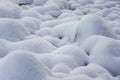 Round rocks near river covered with layer of snow Royalty Free Stock Photo