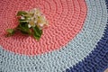 Round rug made of handmade knitted yarn. Royalty Free Stock Photo