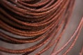 Round rusty steel wire coils. Metal reels for further industrial processing.