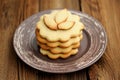 Round sand cakes in pile decorated with small leave cakes on bro