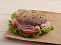 Round sandwich of rye bread with ham, tomato and lettuce Royalty Free Stock Photo