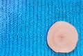 Round saw cut alder on blue knitted fabric background. Royalty Free Stock Photo