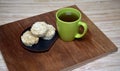 Round shape of fried rice cakes with glass of water in black plate on natural light