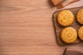 Round shaped moon cake Mooncake - Chinese style pastry during Mid-Autumn Festival / Moon Festival on wooden background and tray,